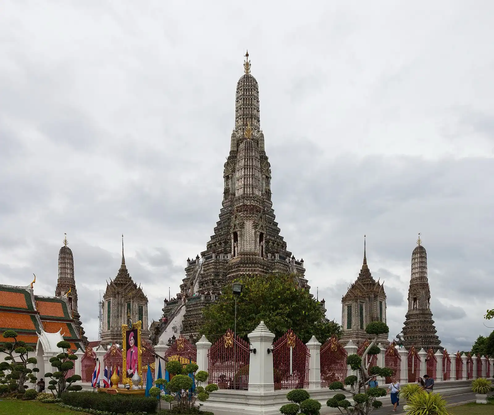 The tiered spire of an ornate temple rising against a cloudy sky.
