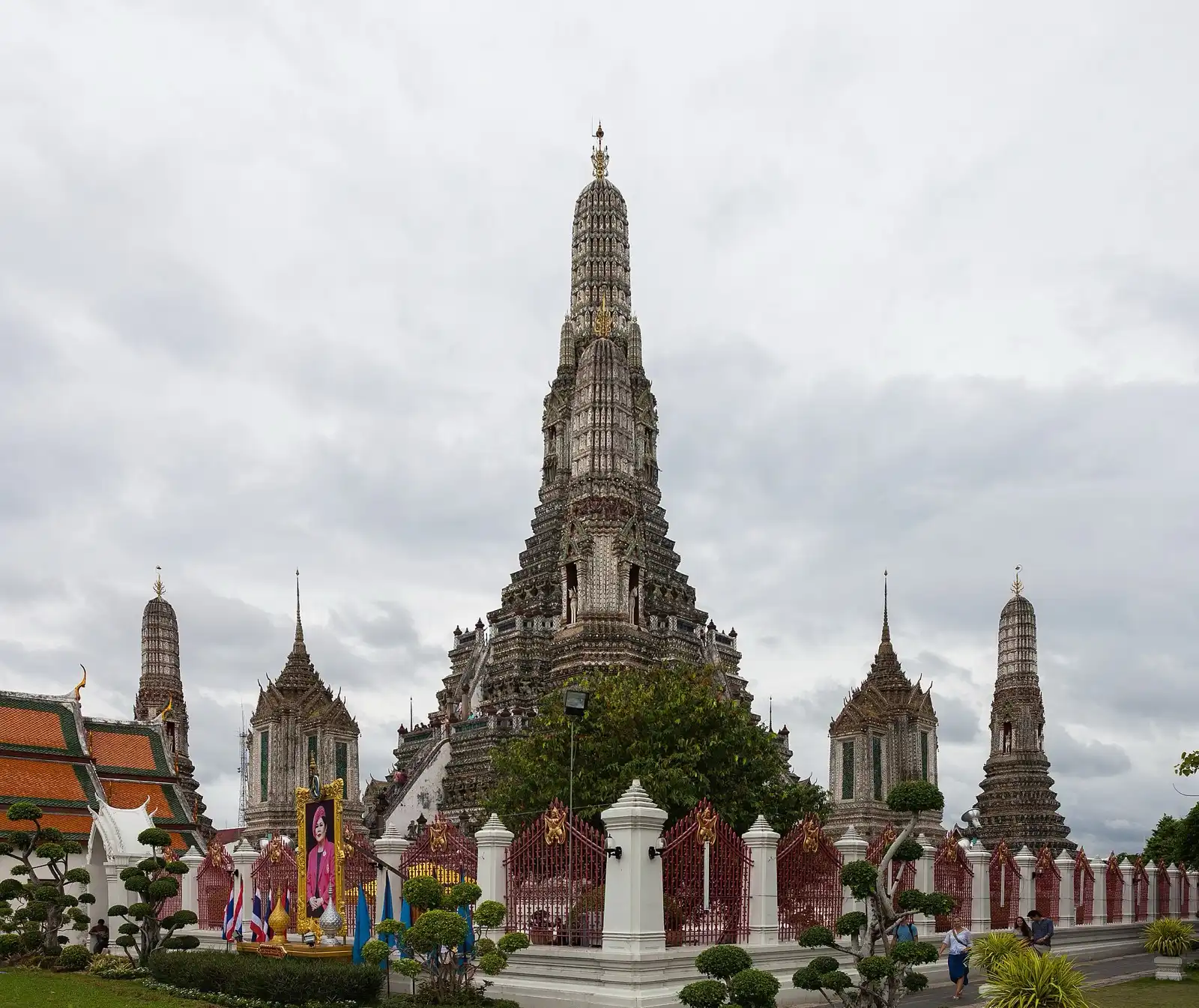 The tiered spire of an ornate temple rising against a cloudy sky.